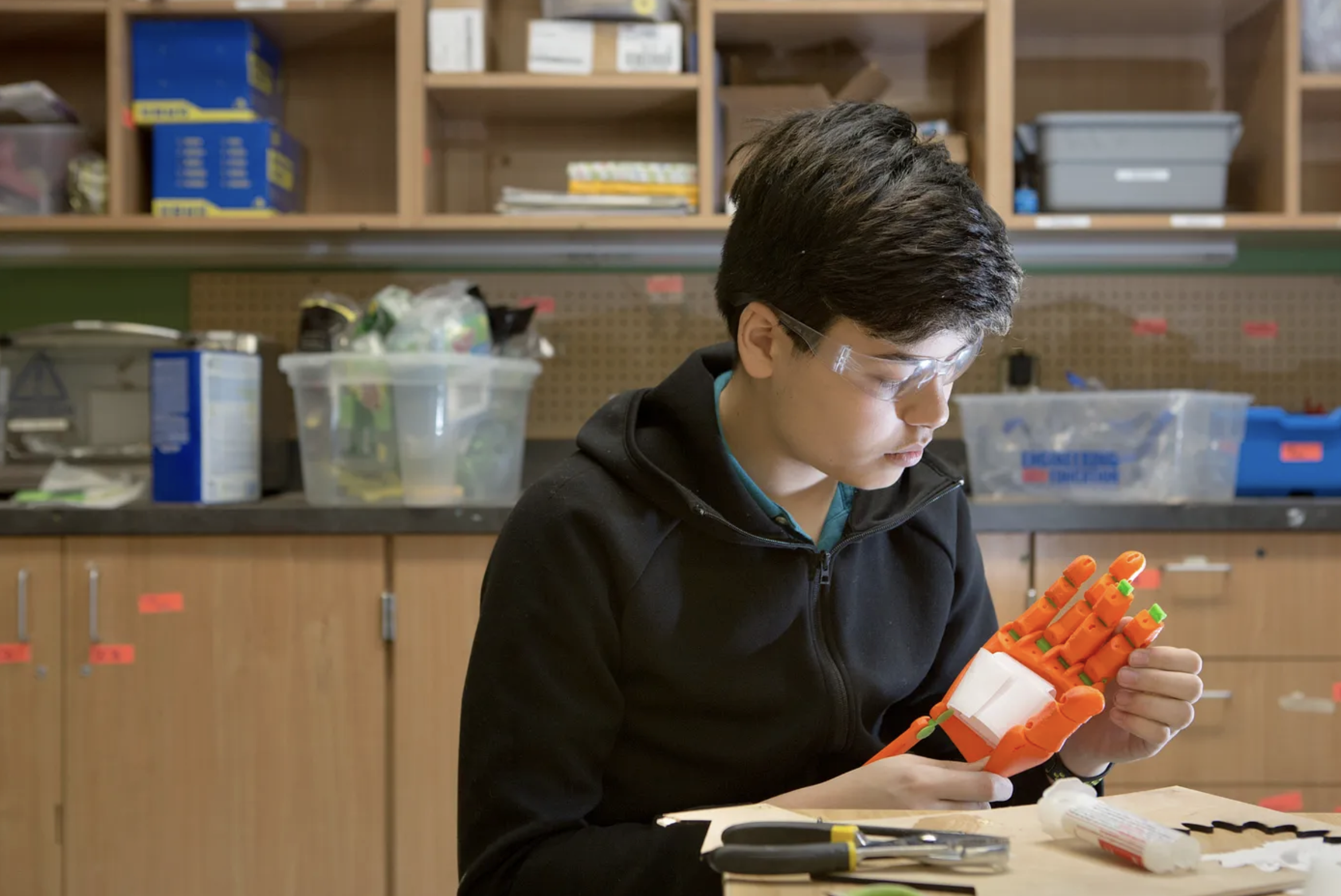 student working on robotic hand